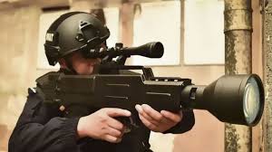 Handheld Directed-Energy Microwave Weapon Operator in helmet and goggles aiming a rifle-shaped directed-energy device with a large circular emitter