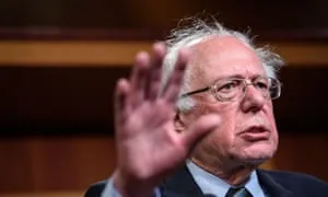 Bernie Sanders speaking passionately about socialism in the U.S. with hand raised for emphasis