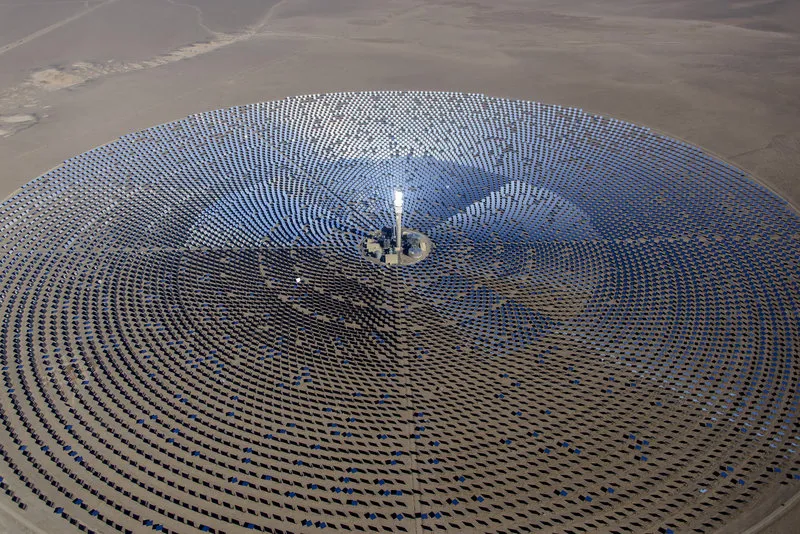 Aerial view of a large solar energy farm with circular solar panels capturing sunlight