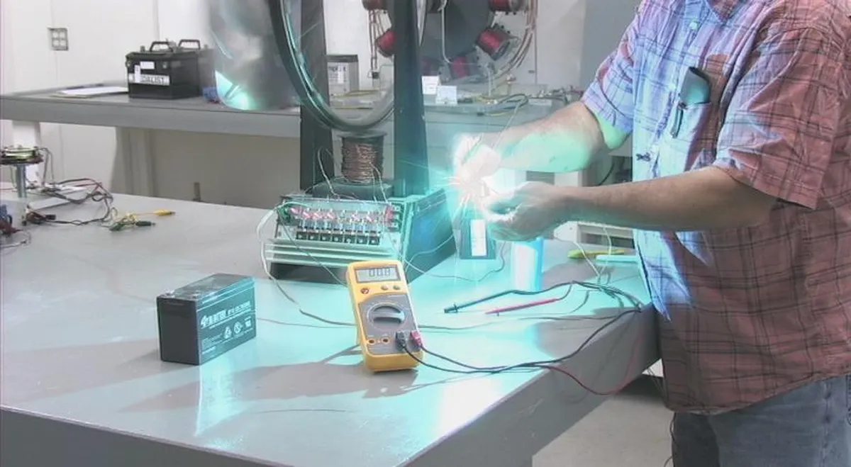 An individual conducting an electrical experiment, measuring voltage with a multimeter and handling equipment in a lab setting