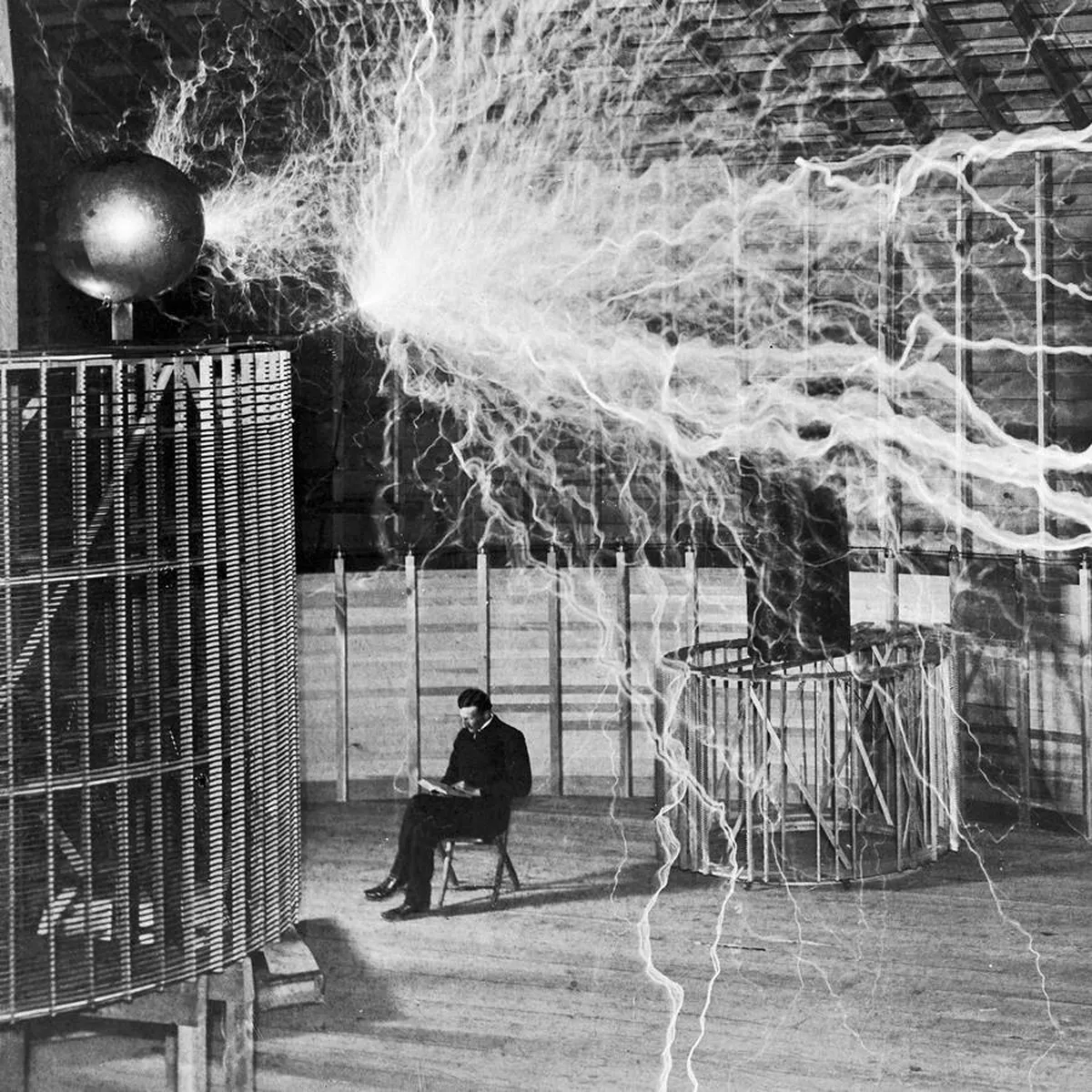 Nikola Tesla conducting an electricity experiment with a Tesla coil emitting sparks