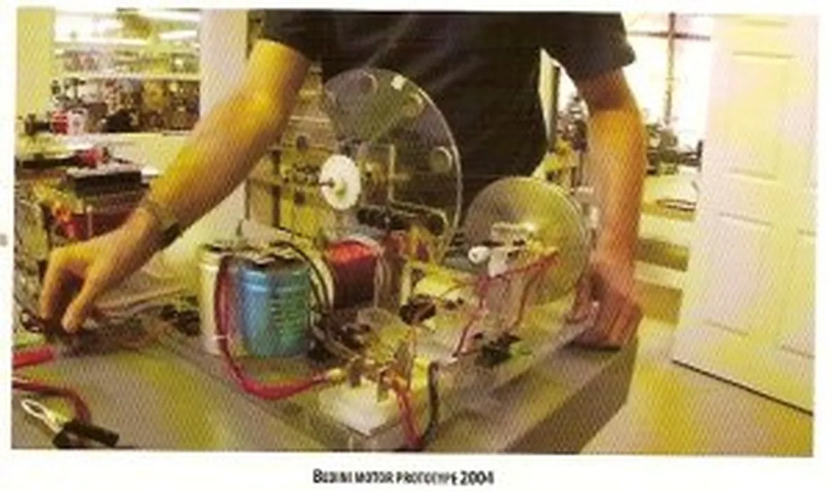 Close-up of a researcher assembling a Nikola Tesla-inspired motor model in a laboratory setting, 2004