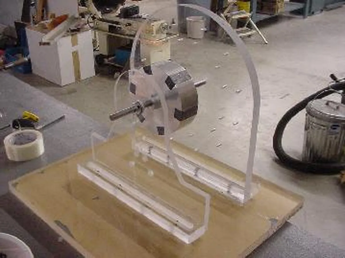 A transparent device inspired by Nikola Tesla's inventions, showcasing a rotor mounted on a clear base, potentially used for demonstrating electromagnetic concepts