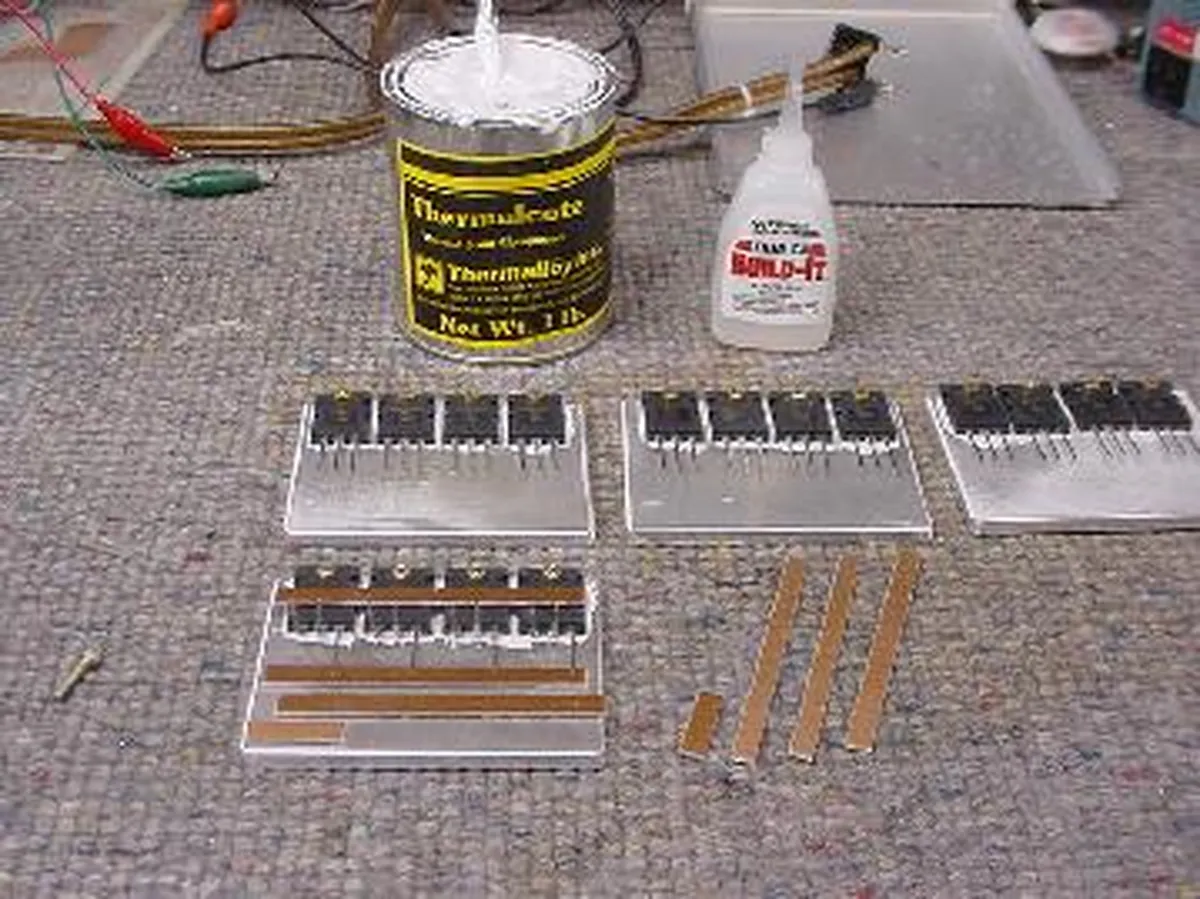 Nikola Tesla's switching mount assembly with thermal paste and adhesives on a work surface