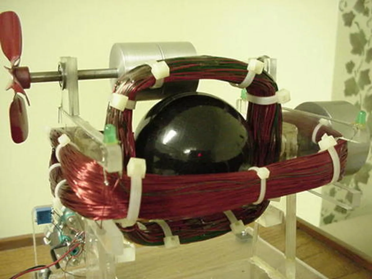 Innovative device inspired by Nikola Tesla's concepts, showcasing wires and a propeller in a clear structure